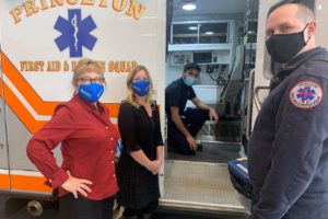 Volunteer EMT Sami Shaikh (inside ambulance) and EMS Captain Shawn Gallagher describe emergency protocols for Northfield Bank representatives Carolyn Sepkowski (left) and Kari Mastroianni at the Princeton First Aid & Rescue Squad.